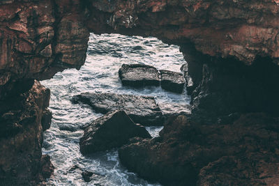 Scenic view of sea by cliff