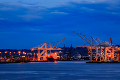 Bridge over river against sky at night