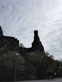 Silhouette of woman against cloudy sky