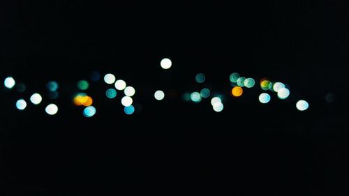 Defocused image of illuminated street lights at night