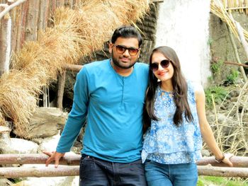 Portrait of smiling young couple standing outdoors