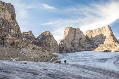 Mountain climber traverses a glacier below mount asgard.