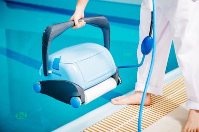 Low section of woman with suitcase on chair