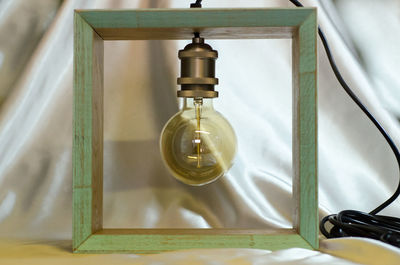 High angle view of illuminated light bulb on table