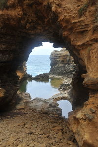 Scenic view of sea seen through cave