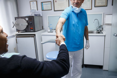 Doctor and patient shaking hands in hospital
