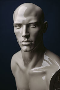 Close-up portrait of mannequin face against black background