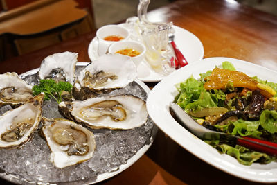 Fresh oyster served with caesar salad