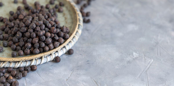 Plate of dry black chickpea from apulia and basilicata in italy on grey table 