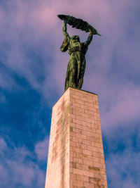 Low angle view of statue against sky