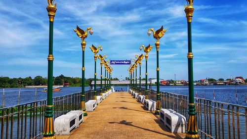 Pier over river against sky