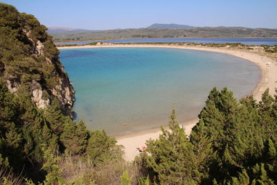 High angle view of sea and trees against sky