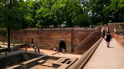 People walking on footpath in city