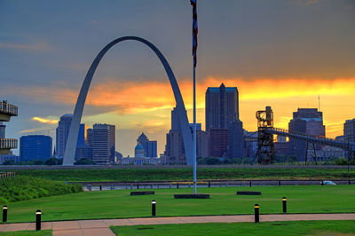 Buildings in city against sky during sunset