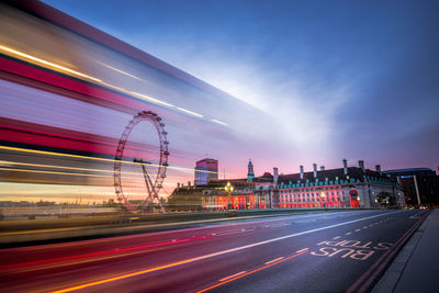 Light trails on road against sky in city