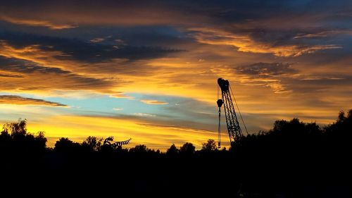 Low angle view of silhouette trees against sky during sunset