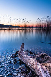 Scenic view of lake against clear blue sky