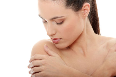 Close-up of a young woman against white background