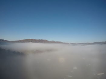 Scenic view of mountains against clear blue sky