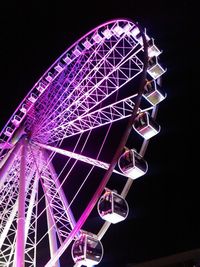 Low angle view of ferris wheel at night