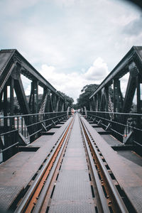 Surface level of footbridge against sky