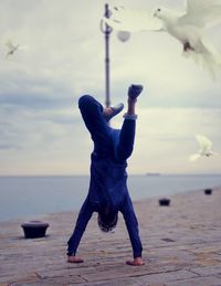 Full length of man on beach against sky