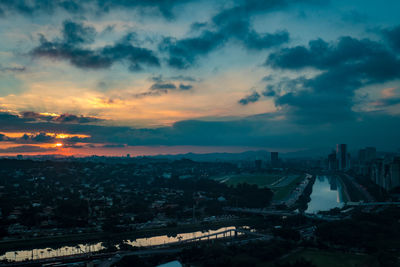 High angle view of road by buildings against sky during sunset