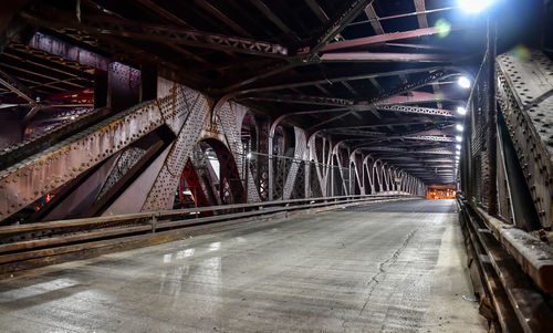 Illuminated bridge in city at night