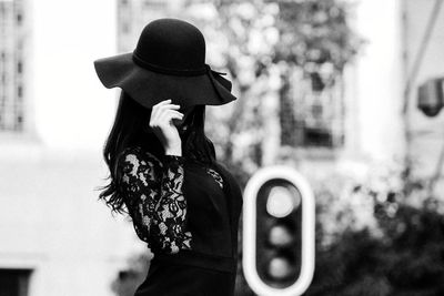 Woman wearing hat while standing outdoors
