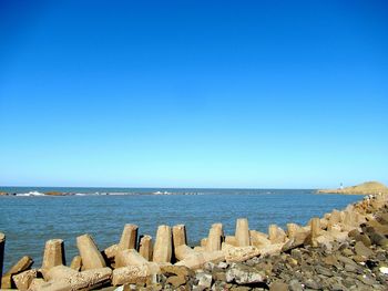 Scenic view of sea against clear blue sky