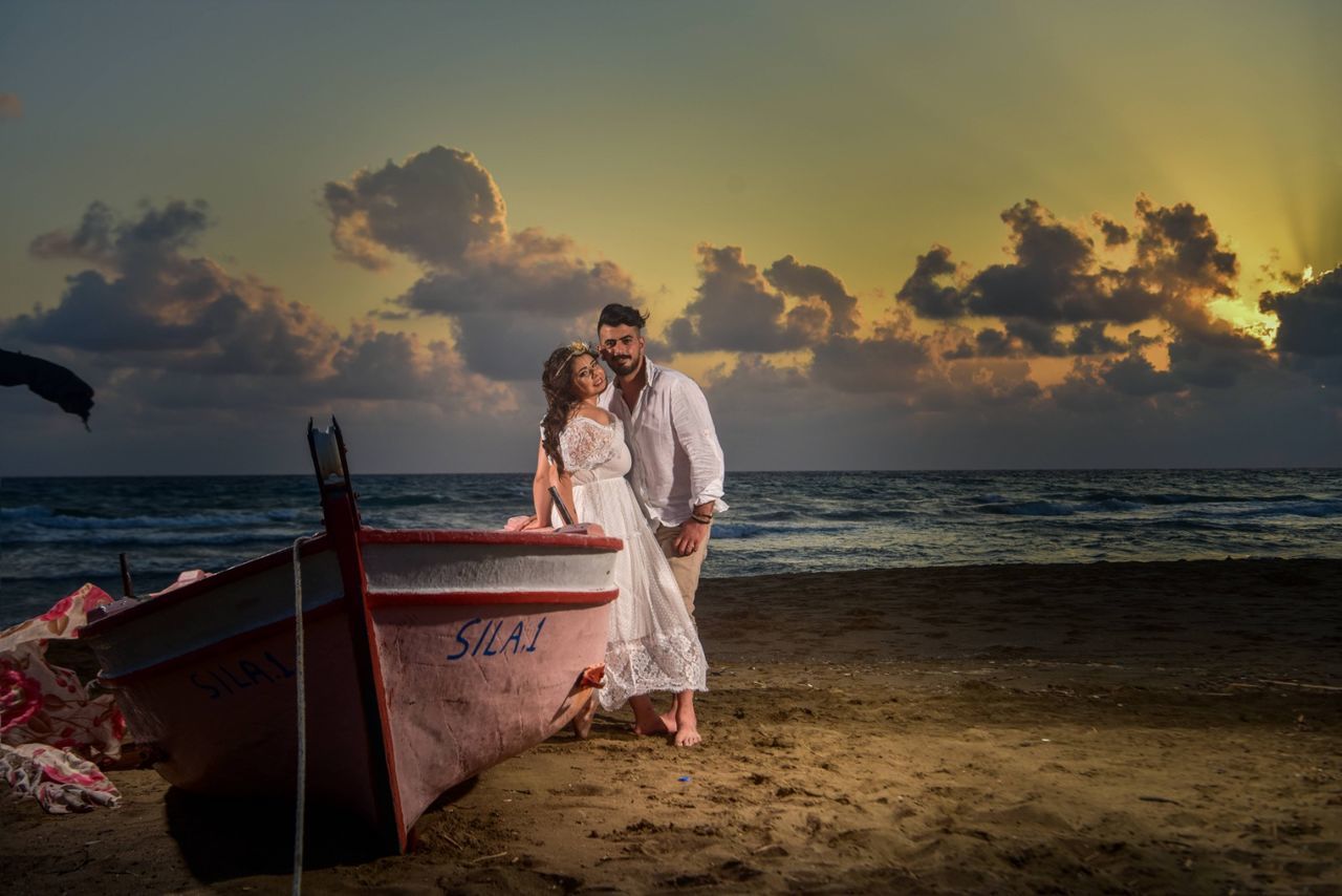 sky, sea, water, beach, land, sunset, real people, beauty in nature, nature, horizon, two people, men, horizon over water, cloud - sky, scenics - nature, lifestyles, standing, full length, young men, couple - relationship, outdoors, positive emotion