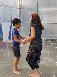 Side view of a mother with child in water
