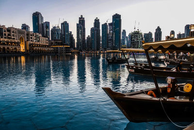 Boats moored in city at waterfront