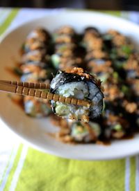 Close-up of chopsticks holding sushi