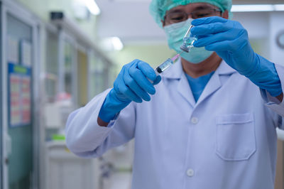 Midsection of person wearing mask