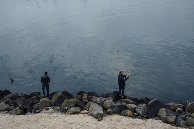 Men fishing at sea shore