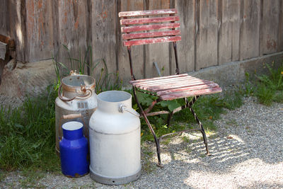 Containers and chair on field