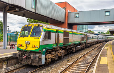 Train at railroad station platform against sky