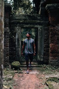 Full length of woman standing in abandoned building