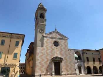 Low angle view of buildings against clear blue sky