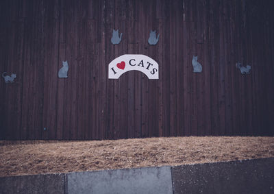 Close-up of text on wooden fence