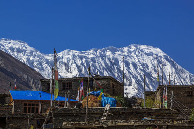 Scenic view of snowcapped mountains against clear blue sky