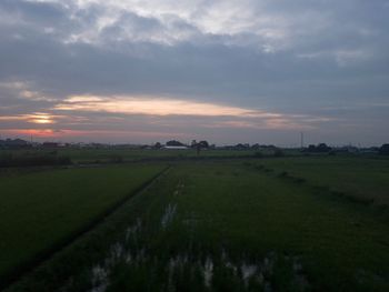 Scenic view of field against sky during sunset