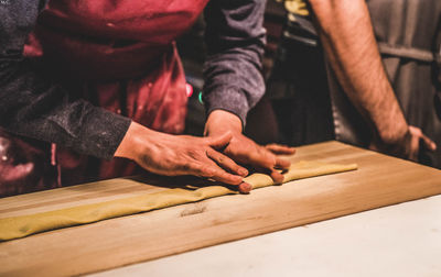 Midsection of man working on table