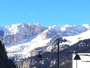 Scenic view of snowcapped mountains against clear blue sky