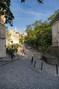 People on street amidst buildings in city
