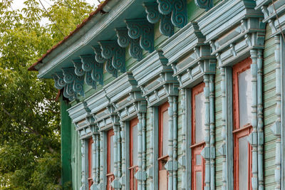 Classic russian wooden house with 6 windows on it, front view poor condition