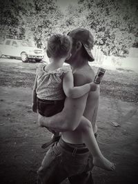 Young woman holding toy while walking on road