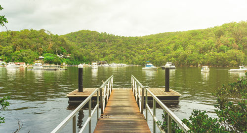 Pier over lake against sky