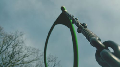 Close-up of chain in park against sky